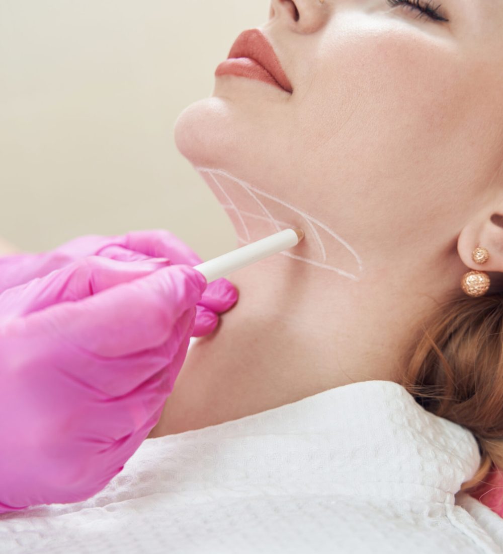 Cropped head side view portrait of elegant woman during the process preparing her neck before the injection in aesthetic clinic