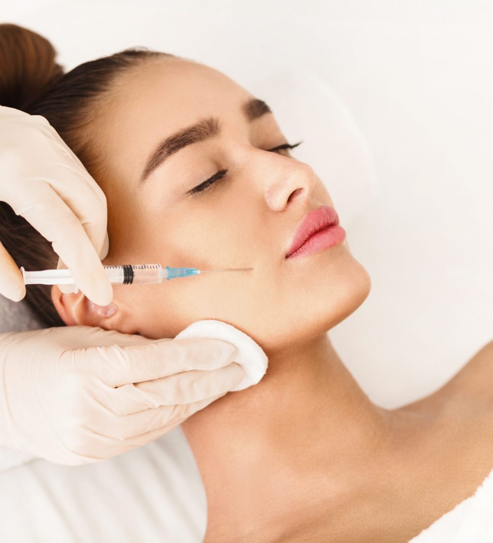 Plastic Surgery. Young Woman Receiving Botox Injection In Beauty Clinic