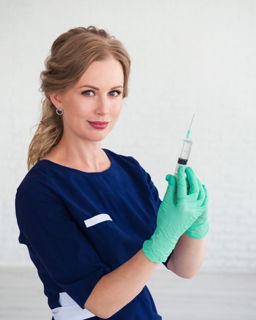 young-woman-cosmetologist-in-blue-uniform-holding-syringe-beauty-face-injection.jpg